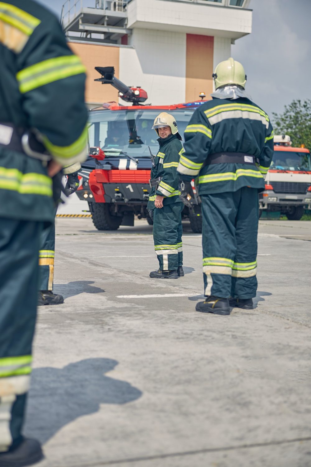 Men going to the red fire truck in the outdoors